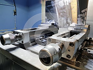 Milling machine clamps in metalworking process. Industrial CNC metal machining by vertical mill.