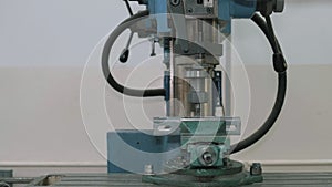 Milling machine cutting the metal workpiece.