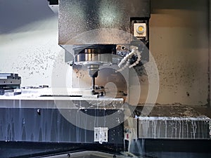 Milling machine in metalworking process. Industrial CNC metal machining by vertical mill.