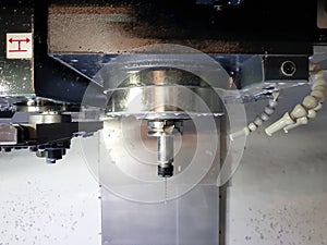 Milling machine in metalworking process. Industrial CNC metal machining by vertical mill.