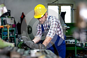 The milling-machine operator works at the lathe.