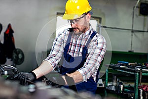 The milling-machine operator works at the lathe.