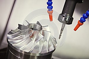 Milling metalworking process. CNC machining of turbine impeller by vertical mill