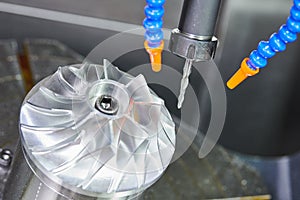 Milling metalworking process. CNC machining of turbine impeller by vertical mill