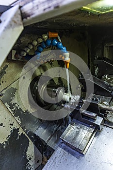 Milling metalworking process. Industrial CNC metalworking with vertical mill. Metalworking industry: cutting steel metal shaft