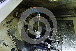 Milling metalworking process. Industrial CNC metalworking with vertical mill. Metalworking industry: cutting steel metal shaft