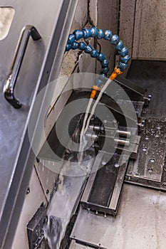 Milling metalworking process. Industrial CNC metalworking with vertical mill. Metalworking industry: cutting steel metal shaft