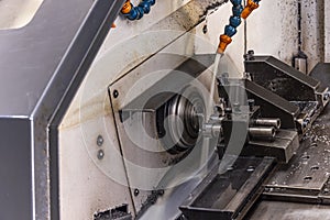 Milling metalworking process. Industrial CNC metalworking with vertical mill. Metalworking industry: cutting steel metal shaft