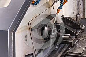 Milling metalworking process. Industrial CNC metalworking with vertical mill. Metalworking industry: cutting steel metal shaft