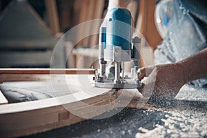 Milling wood in the joinery using manual mechanical cutters. photo