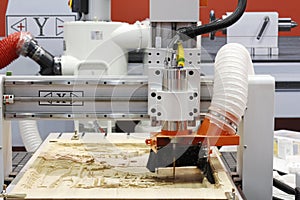 Milling a wooden board. CNC woodworking machine