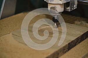 Milling a wooden board. Processing of wood panels on CNC coordinate milling woodworking machines. Slow motion video
