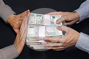 A million rubles in men's hands. Bribery in Russian rubles in a dark room. The concept of corruption and bribery. rejection of