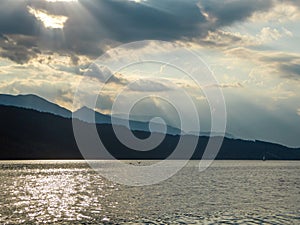 Millstaettersee - A pair of swans landing on Millstaetter lake in Austria during the sunset. The lake is surrounded by high Alps