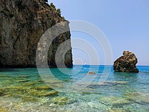 Milos beach with rock in the sea.