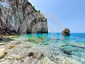 Milos beach with rock in the sea.