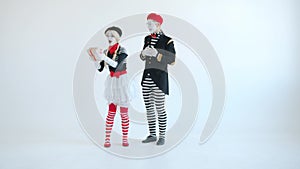 Mime actress getting present from man kissing running away with gift box on white background