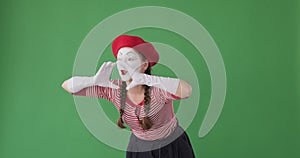 Mime artist shouting with hands cupped around mouth