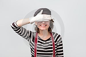 Mime caucasian woman covering her eyes waiting for surprise.