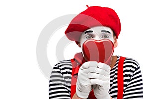 mime covering face with heart shaped gift box