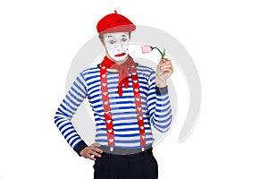 Mime with flower.Emotional funny actor wearing