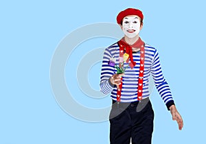 Mime with flower.Emotional funny actor wearing