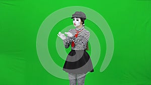 Mime girl found flower, sniffing, sortilege on it. Chroma key.