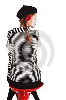 Mime girl hugging herself