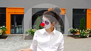 Mime girl waving beckoning with one finger and smiling playfully to camera, inviting to follow