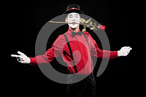 mime holding red rose in mouth and standing with open arms