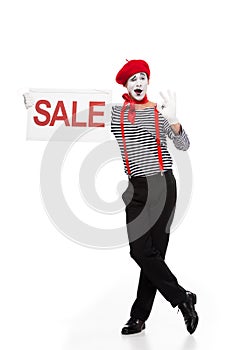 mime holding sale signboard and showing ok sign