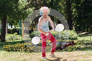 Mime performs in the park with balloons. Clown shows pantomime on the street