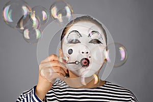 Mime portrait blowing bubbles