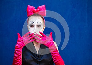 Mime portrait near a blue wall.  on blue background