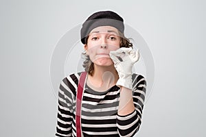 Mime pretty woman zipping her mouth shut photo