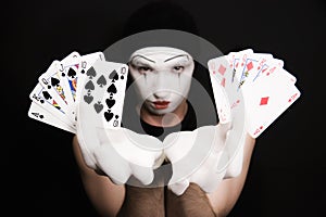 Mime with royal flush on a black background