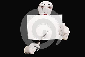 Mime with scissors on black background