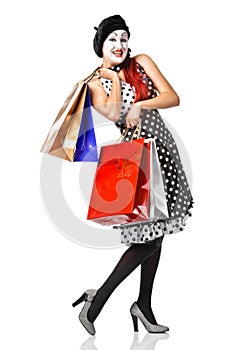 Mime in spotty dress holding shopping bags