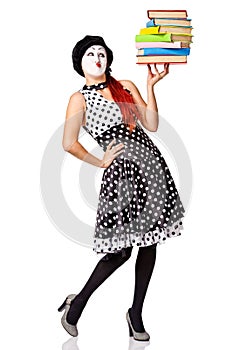 Mime in spotty dress holding stack books