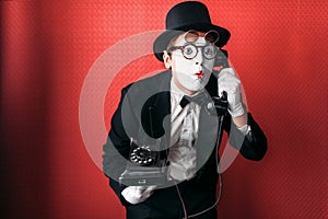 Mime theater actor performing with old telephone