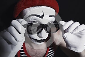 Mime wearing red hat and eyeglasses
