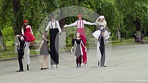 Mimes dance with stilts at the street