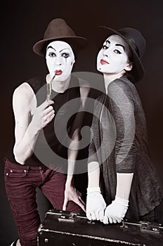 mimes woman and man with suitcase