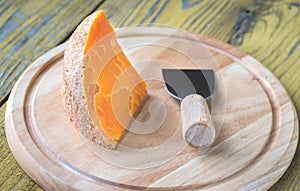Mimolette cheese on the wooden board