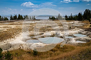 Mimulus Pool, a thermal feature in the West Thumb Geyser Basin of Yellowstone National Park. Yellowstone Lake in background