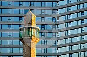 Minaret against hotel.