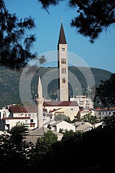 Minaret And Bell Tower In Mostar, Bosnia And Herzegovina