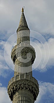 Minaret of The Blue Mosque Istanbul Turkey against a cloudy sky