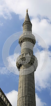 Minaret of The Blue Mosque Istanbul Turkey against a cloudy sky