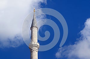 The minaret of the Fatih mosque on the blue sky background